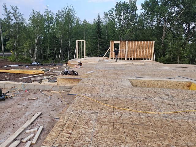 Foundation preparation and wood framing layout for a residential home beginning wall framing.
