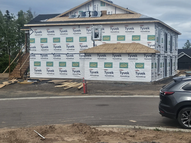 Two-storey four unit building framing completed ready for siding and roofing.