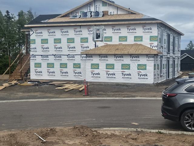 Two-storey four unit building framing completed ready for siding and roofing.